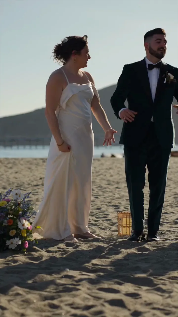 Carla and Joe walking on the beach at dusk